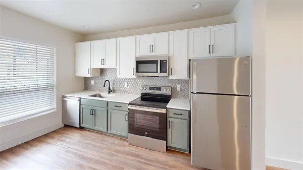 a kitchen with a refrigerator stove and sink