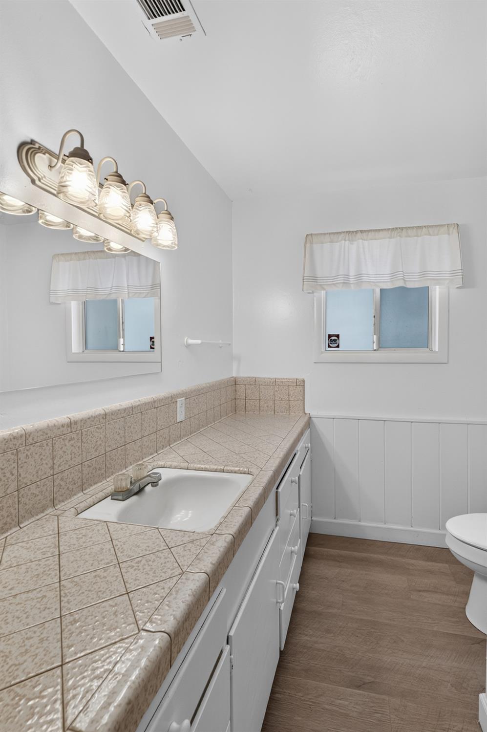 10700 Calvine Road Elk Grove, CA 95830 - Photo 35 of 73 a bathroom with a sink and a mirror