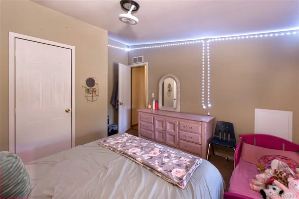 a bedroom with a bed and a dresser