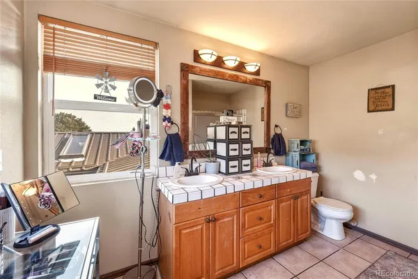 a bathroom with a toilet a sink and a mirror