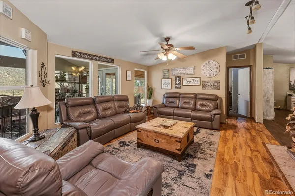 a living room with furniture fireplace and a window