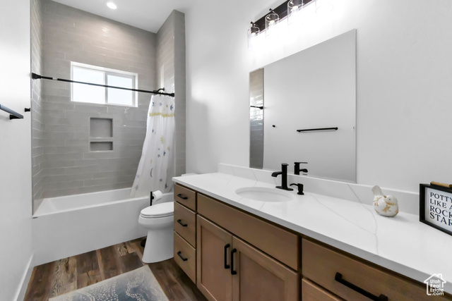 1952 Highway 118 Monroe, UT 84754 - Photo 36 of 88 Bathroom featuring vanity, wood finished floors, and shower / tub combo with curtain