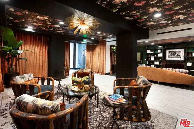 a lobby with furniture and chandelier