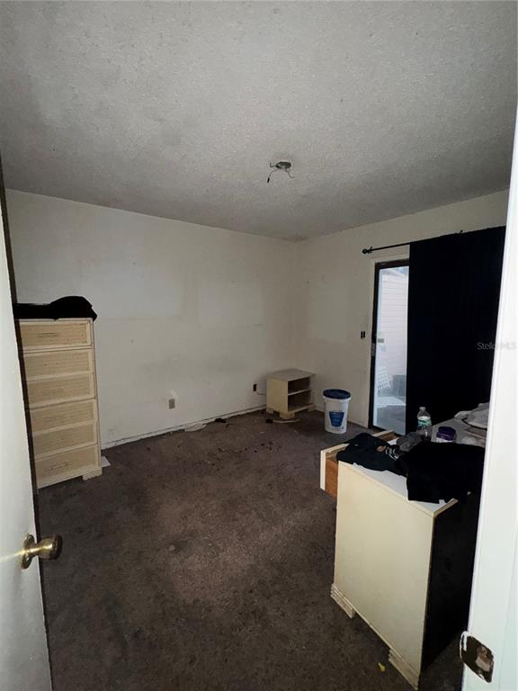 11001 Southeast Sunset Harbor Road, Unit D21 Summerfield, FL 34491 - Photo 14 of 15 a room with furniture and flat screen tv