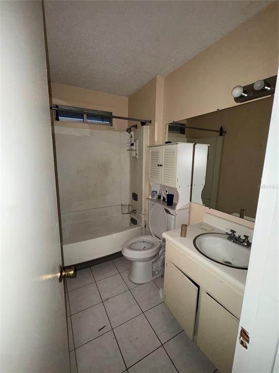 11001 Southeast Sunset Harbor Road, Unit D21 Summerfield, FL 34491 - Photo 15 of 15 a bathroom with a granite countertop bathtub shower sink vanity and toilet