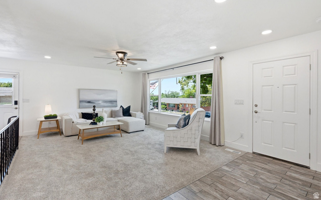 120 North 1230 E Street Springville, UT 84663 - Photo 6 of 60 Spacious living area featuring light-toned carpeting, ample natural light from a large window, recessed lighting, and a ceiling fan