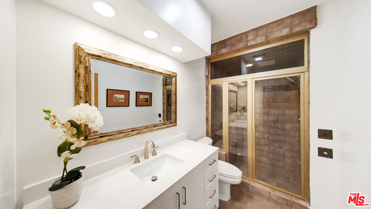 2312 Kimridge Road Beverly Hills, CA 90210 - Photo 48 of 60 a bathroom with a sink toilet and shower