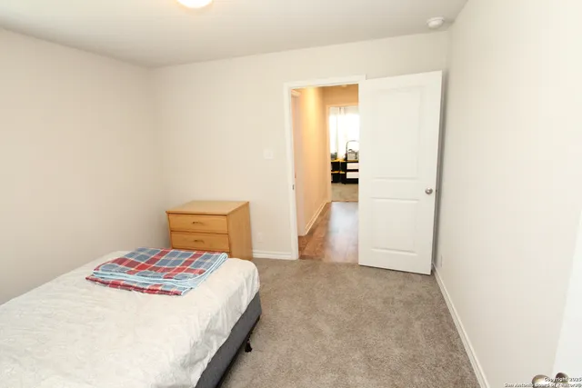 a bedroom with a bed and cabinets