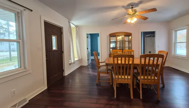 a view of a a dining room with furniture window and wooden floor