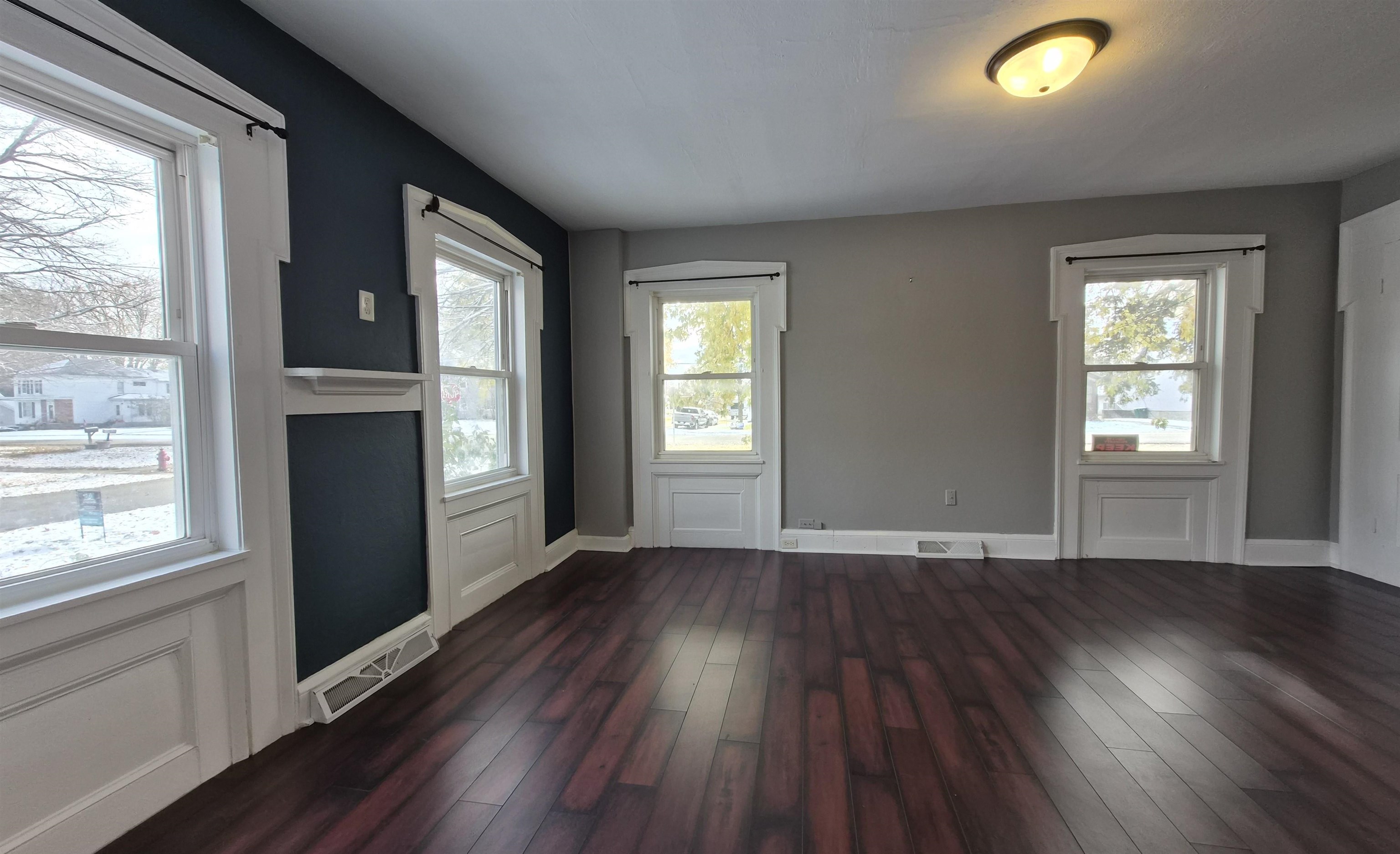 301 West Main Street Durand, IL 61024 - Photo 12 of 32 an empty room with wooden floor and windows
