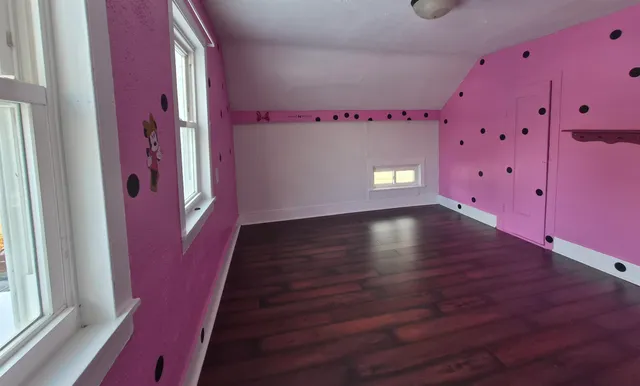 a view of an entryway with wooden floor