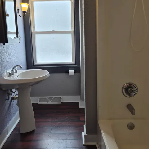 a bathroom with a sink a mirror and a bathtub