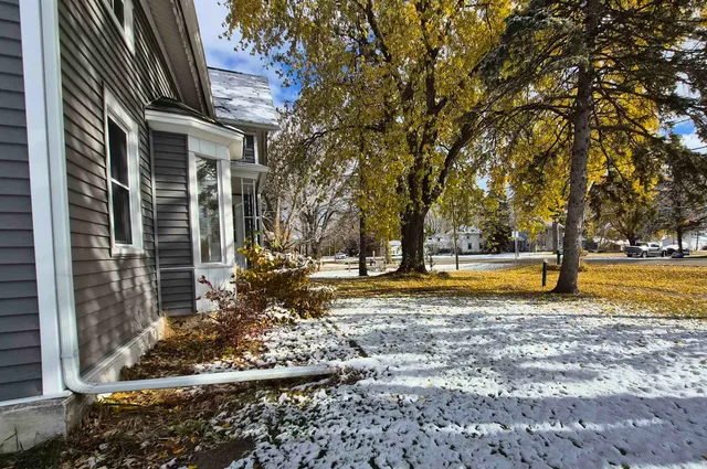 a view of a house with backyard and sitting area