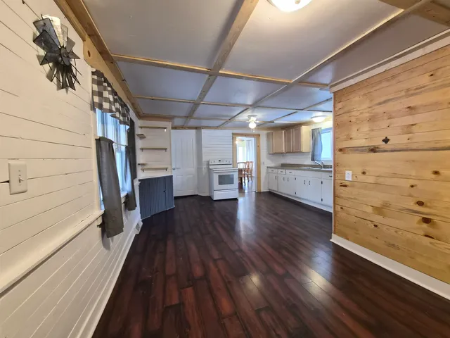a view of walk in closet with wooden floor and stairs
