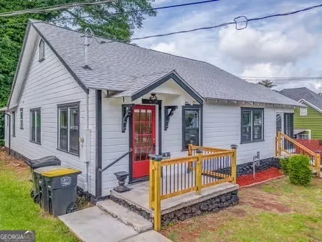 a view of a house with a tub and wooden fence