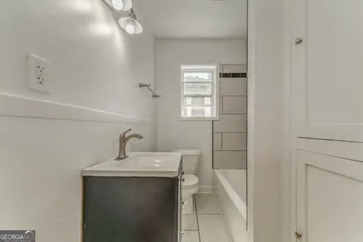 a bathroom with a sink a vanity and window