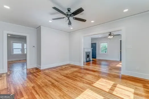 a view of a livingroom with wooden floor and a ceiling fan