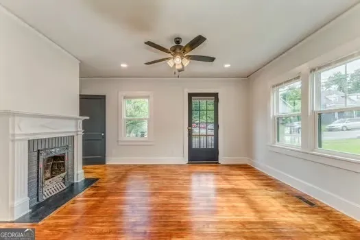 a view of an empty room with window and fireplace