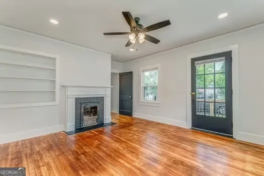 a view of an empty room with a fireplace and a window