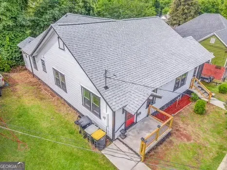 an aerial view of residential houses with outdoor space and street view