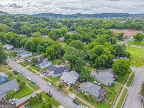 an aerial view of residential houses with outdoor space and street view