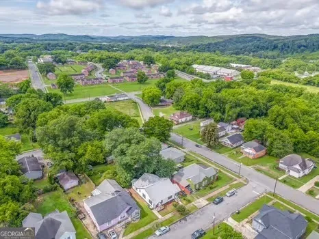 an aerial view of multiple houses with yard
