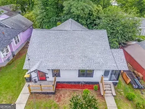 an aerial view of a house with a garden and a yard