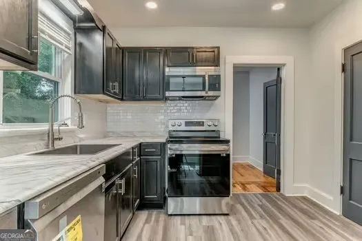 a kitchen with stainless steel appliances granite countertop a stove and a sink