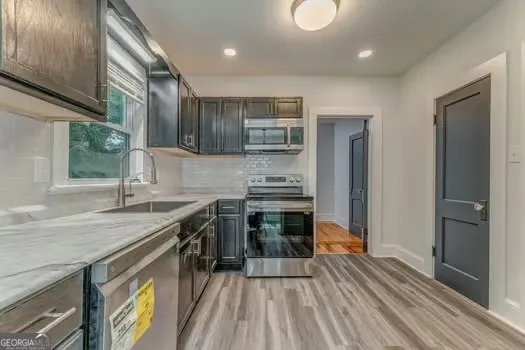 a kitchen with a sink stove and refrigerator