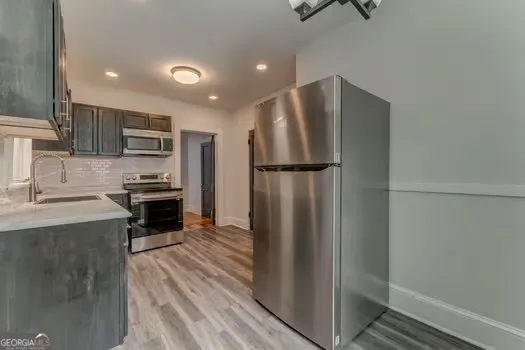 a kitchen with stainless steel appliances a refrigerator and a stove