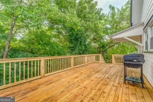a view of balcony with wooden floor and outdoor seating