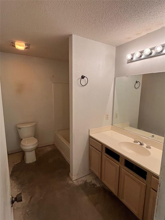 105 East Foggle Street Athens, TX 75751 - Photo 11 of 21 a bathroom with a sink a toilet a mirror and vanity