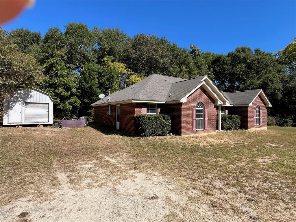105 East Foggle Street Athens, TX 75751 - Photo 2 of 21 a front view of a house with a yard and garage