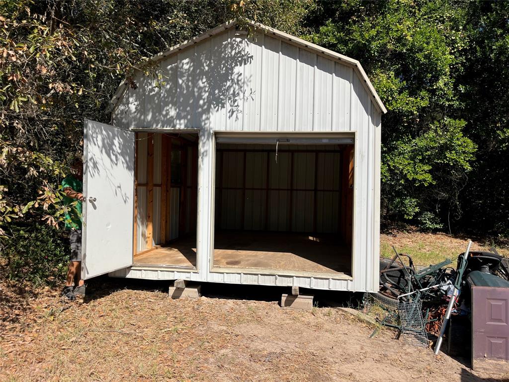 105 East Foggle Street Athens, TX 75751 - Photo 9 of 21 a view of backyard with small cabin