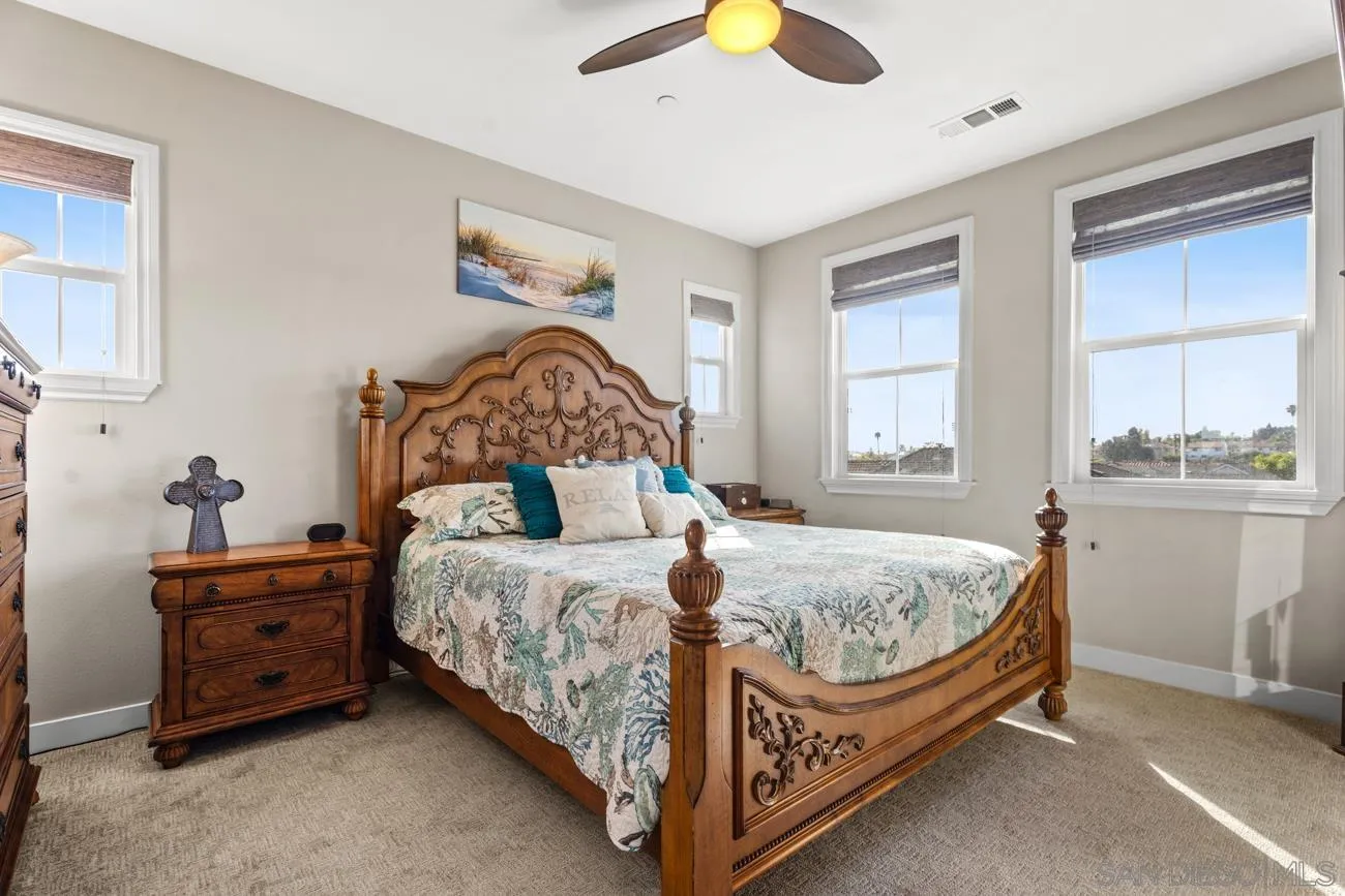 4326 Star Path Way, Unit 1 Oceanside, CA 92056 - Photo 27 of 46 a bed sitting in a bedroom next to a window