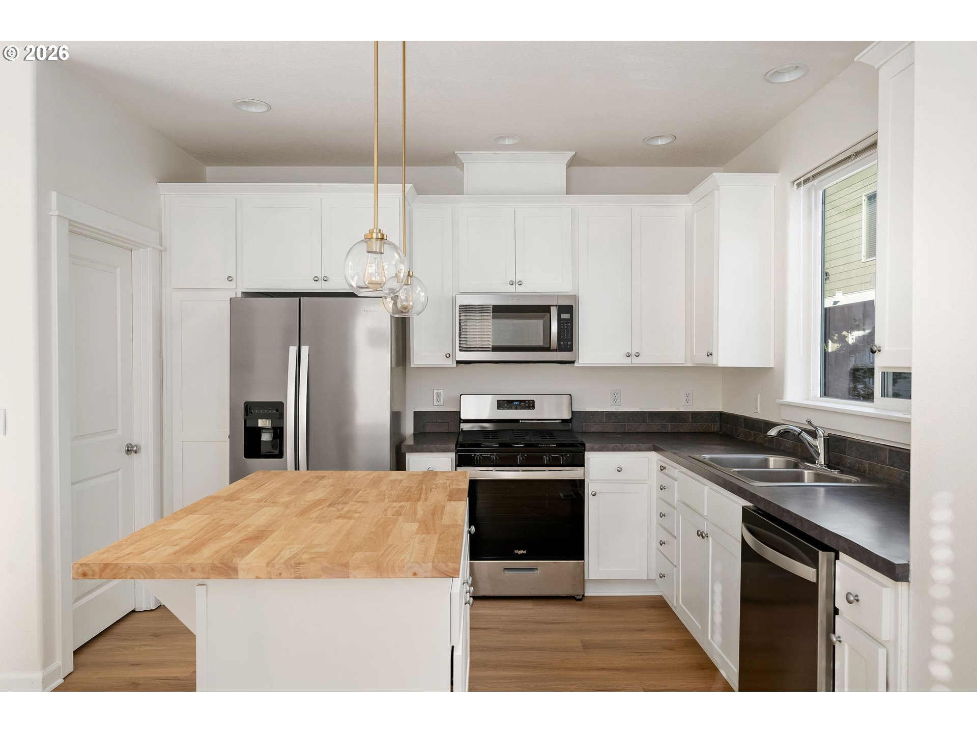 1190 Southwest 162nd Avenue Beaverton, OR 97006 - Photo 19 of 36 a kitchen with stainless steel appliances granite countertop a sink stove and refrigerator