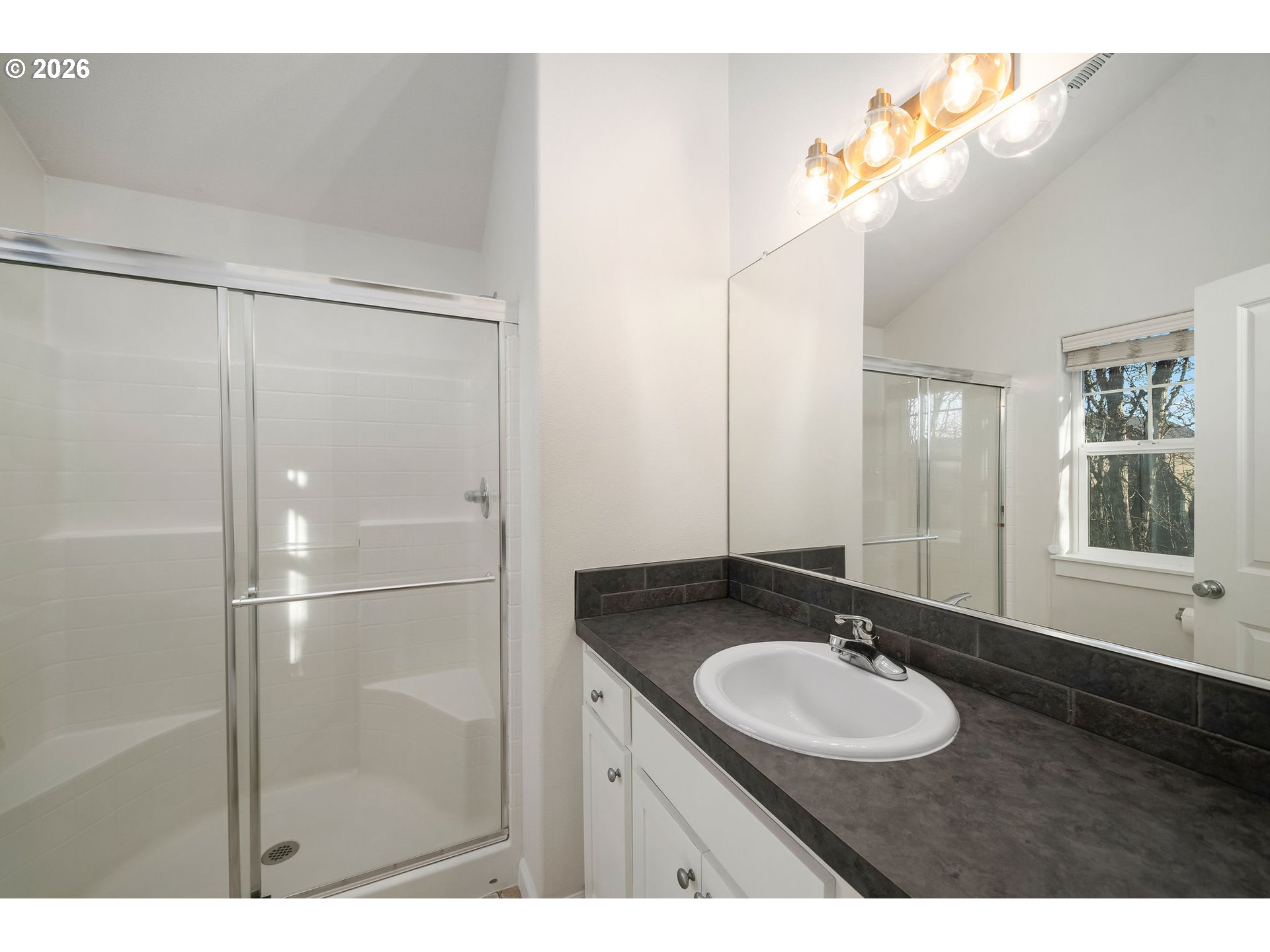 1190 Southwest 162nd Avenue Beaverton, OR 97006 - Photo 26 of 36 a bathroom with a sink mirror and a shower