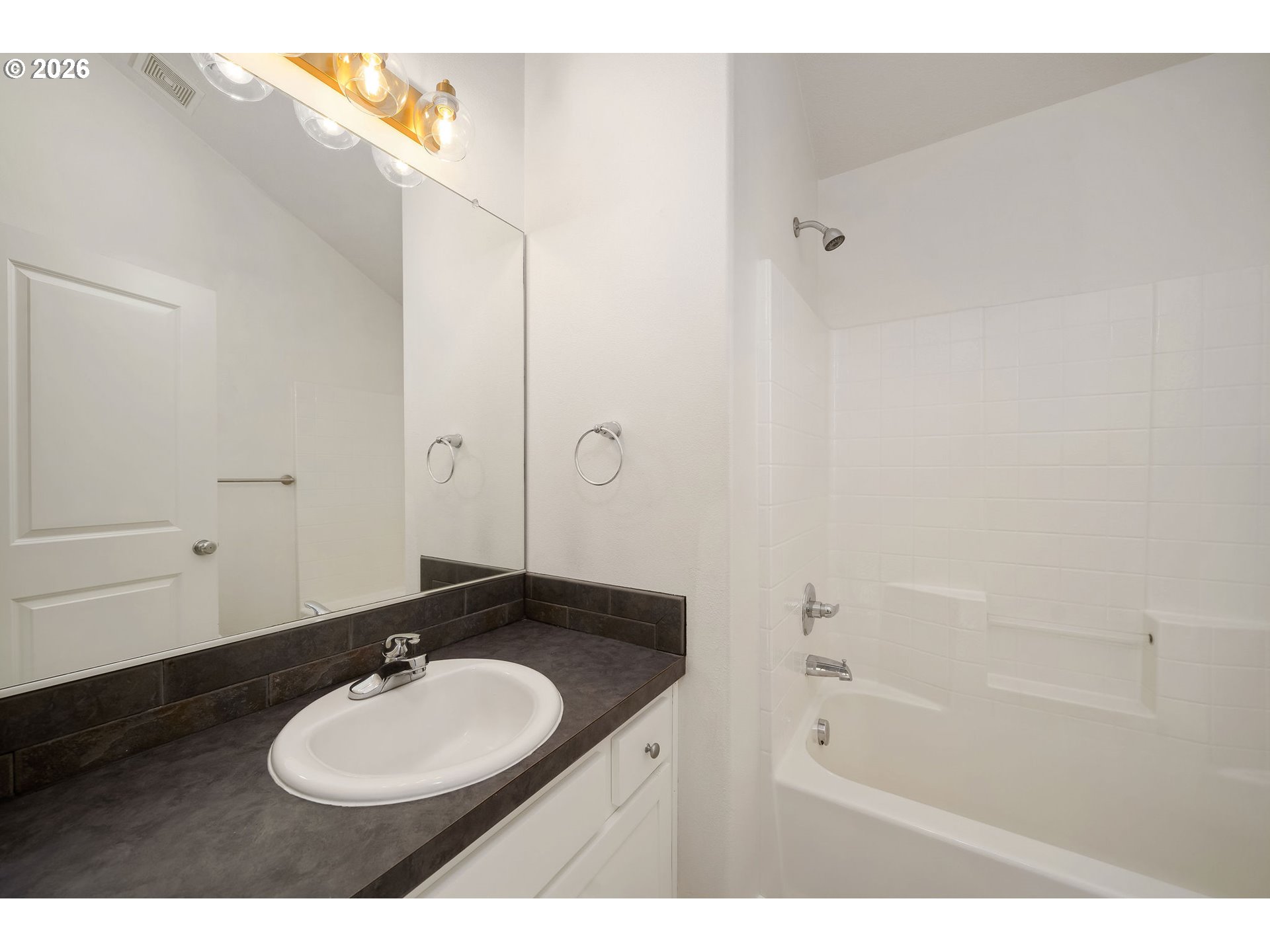 1190 Southwest 162nd Avenue Beaverton, OR 97006 - Photo 30 of 36 a bathroom with a sink vanity granite tub and a mirror