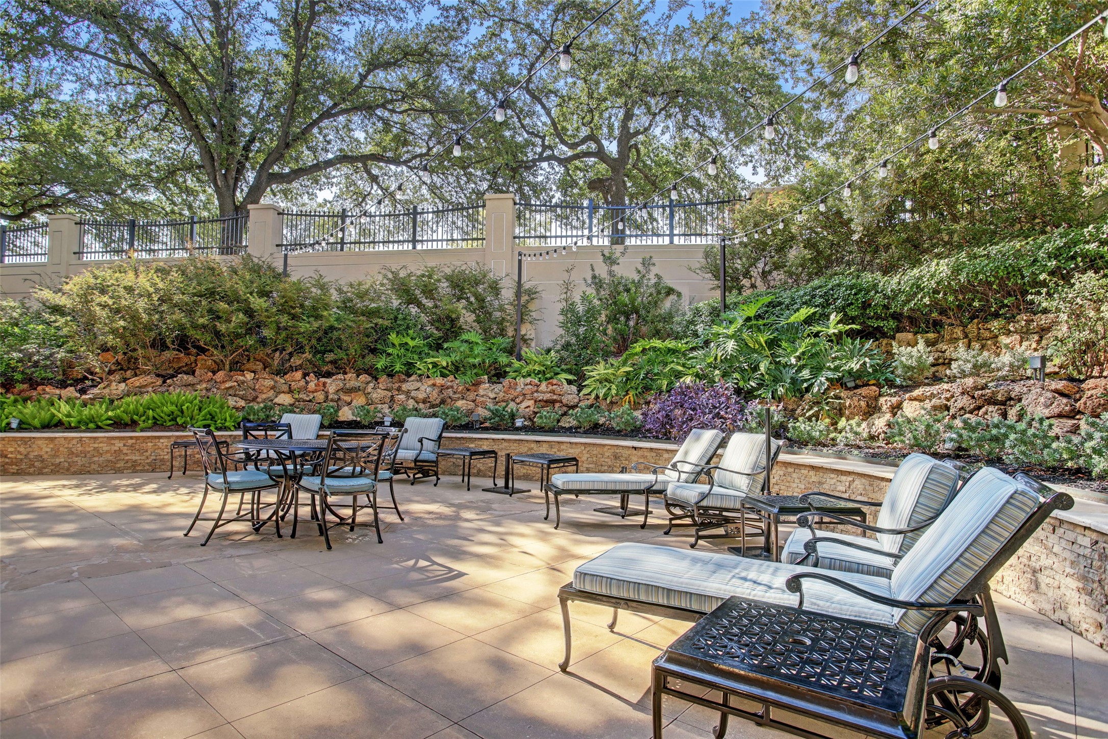 2001 Holcombe Boulevard, Unit 504 Houston, TX 77030 - Photo 26 of 38 a view of a patio with table and chairs and potted plants