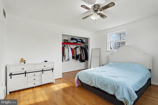 a spacious bedroom with a bed and a walk in closet