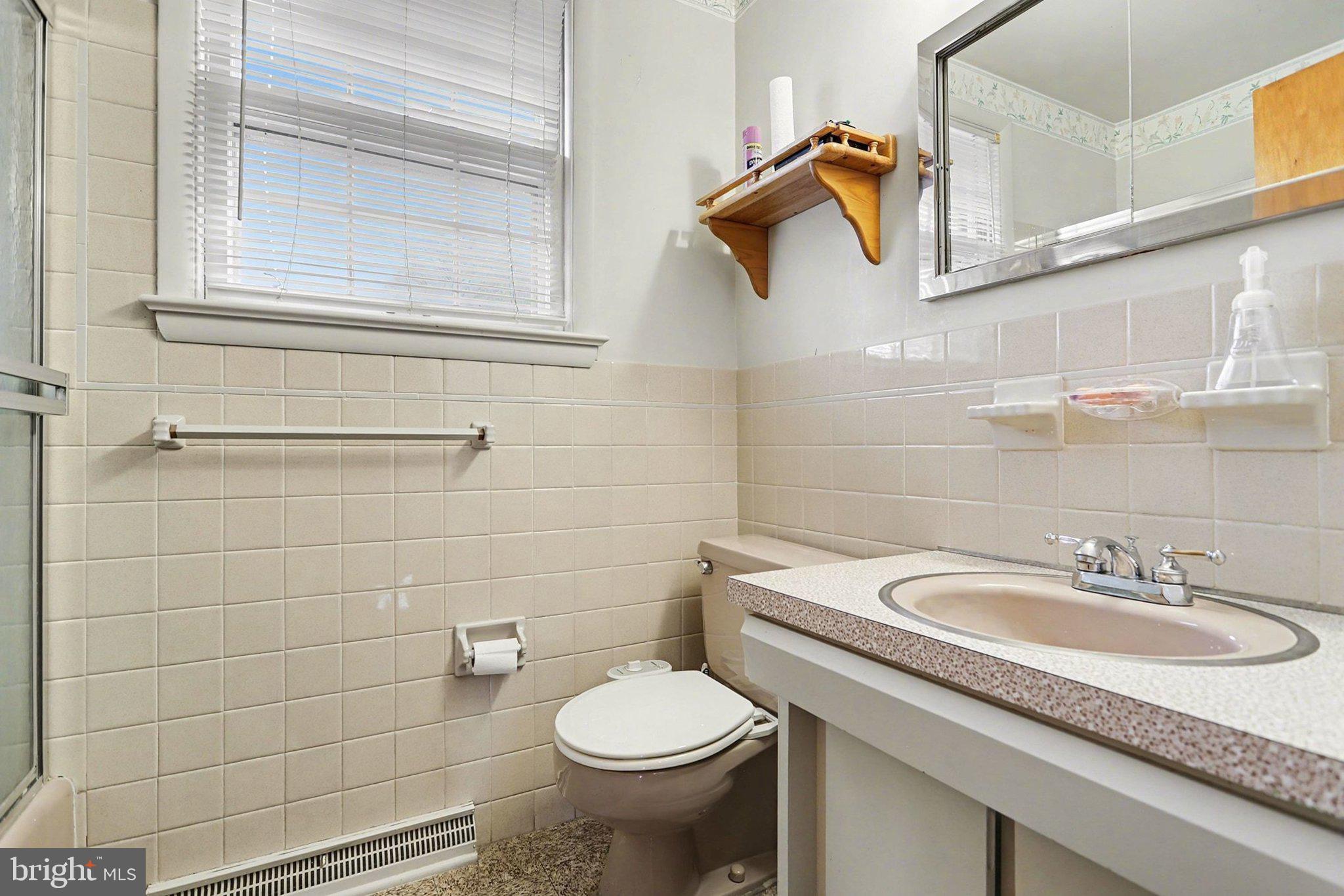 2072 Andover Drive Dover, PA 17315 - Photo 23 of 30 a bathroom with a granite countertop toilet sink and mirror