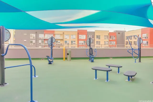 a patio with a table and chairs and potted plants