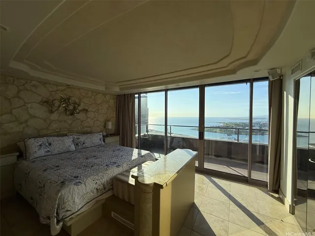 a bedroom with a bed and a balcony view