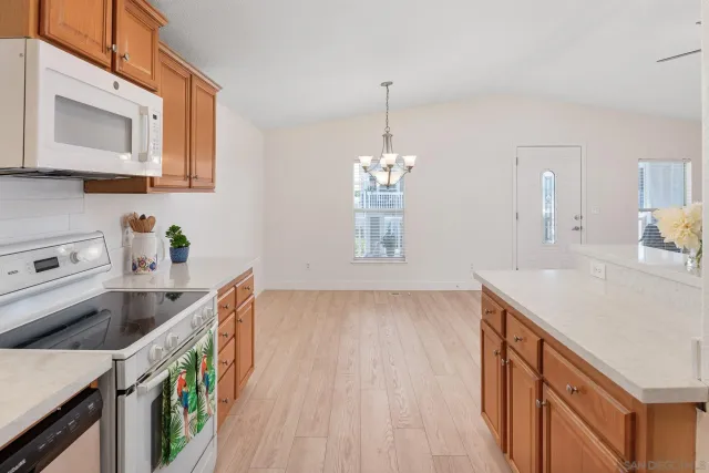 a kitchen that has a sink and a stove in it