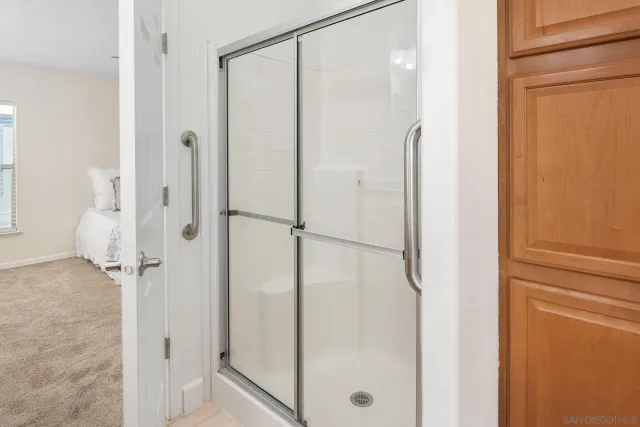 a bathroom with a glass shower door