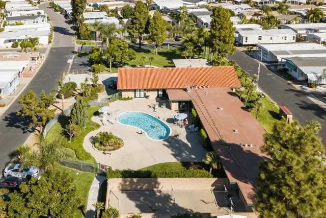 an aerial view of a house with a swimming pool a yard and a patio