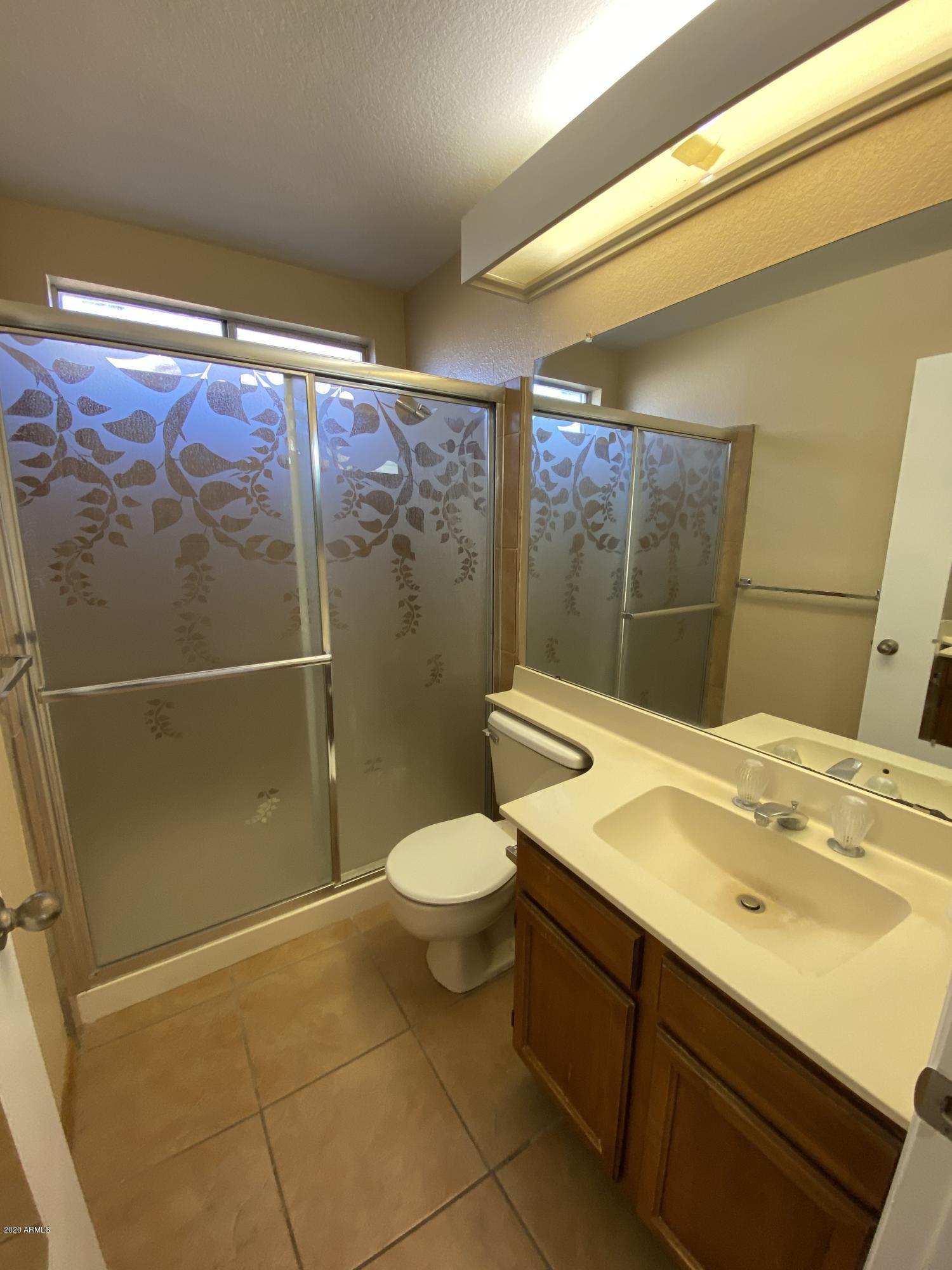 6932 West Paradise Drive Peoria, AZ 85345 - Photo 12 of 15 a bathroom with a sink a toilet and shower