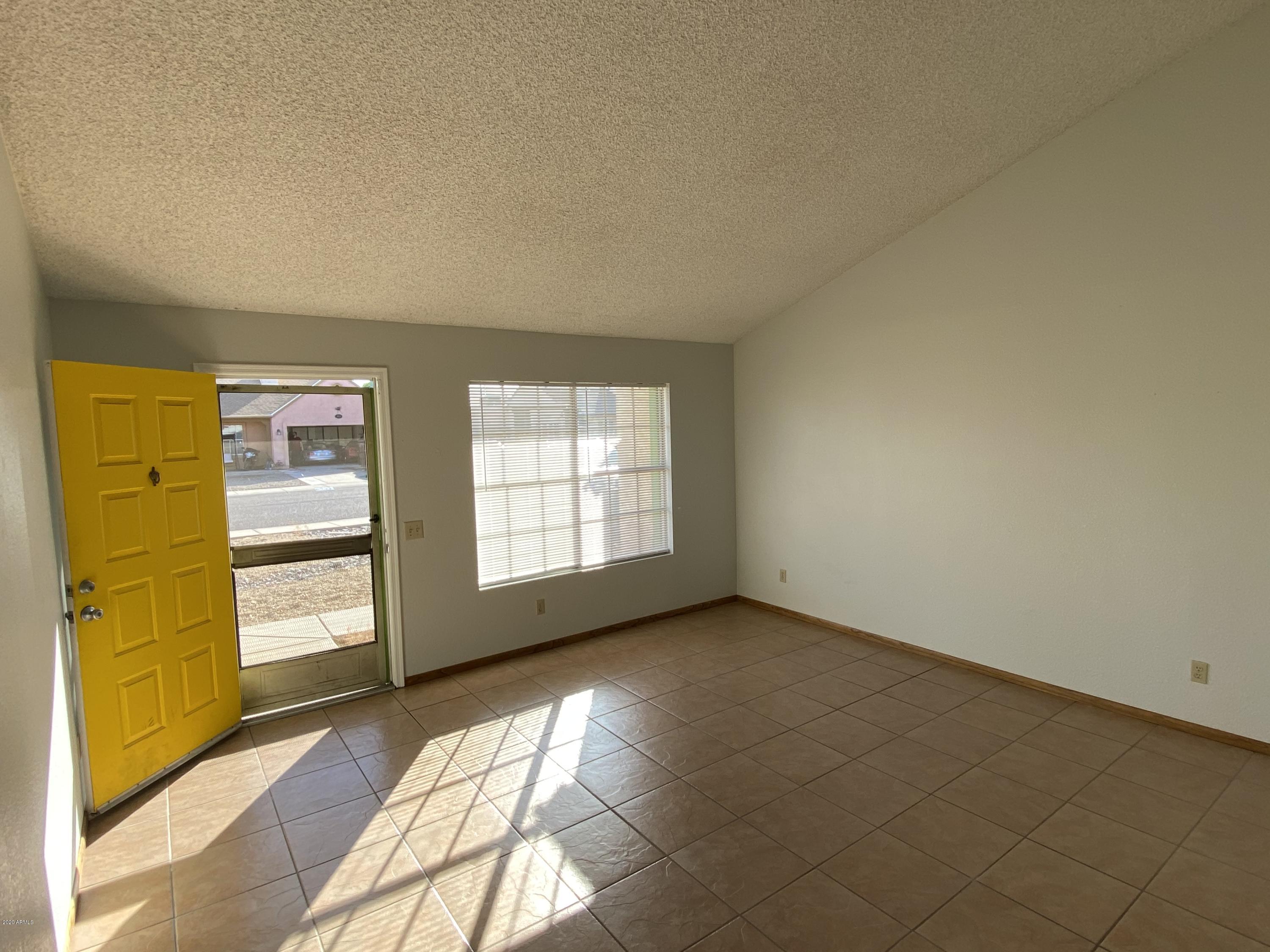 6932 West Paradise Drive Peoria, AZ 85345 - Photo 4 of 15 a view of an empty room and a window