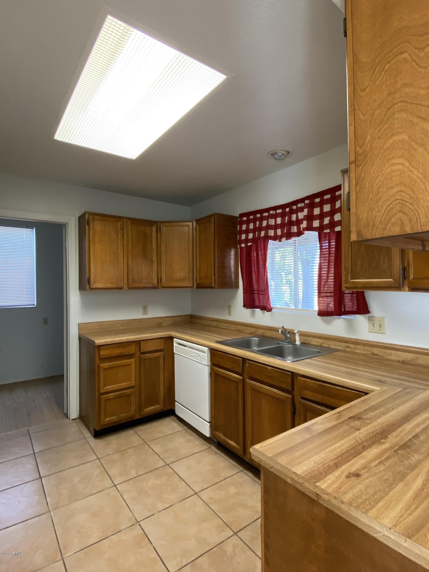 6932 West Paradise Drive Peoria, AZ 85345 - Photo 5 of 15 a kitchen with a sink and cabinets