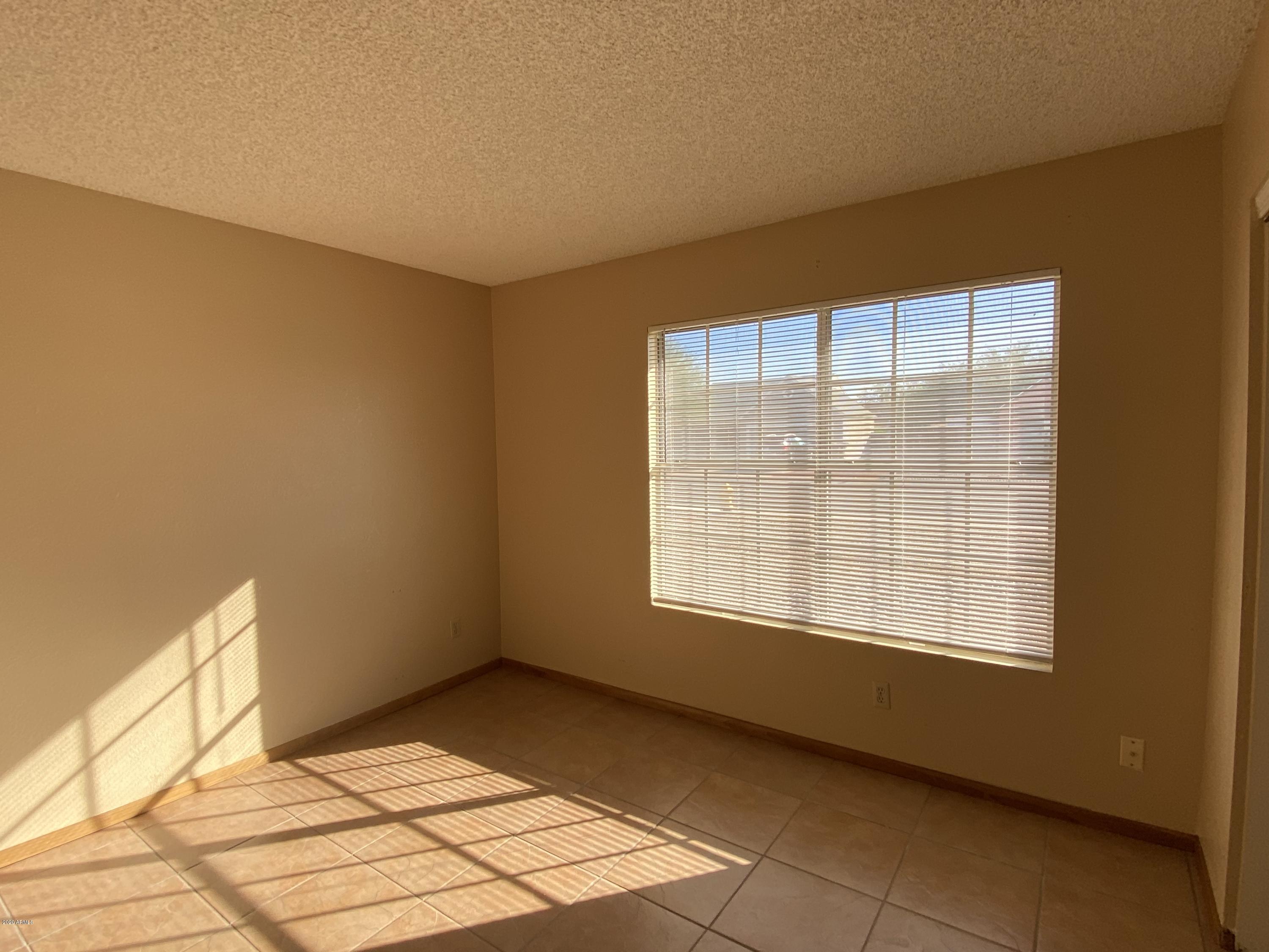 6932 West Paradise Drive Peoria, AZ 85345 - Photo 9 of 15 a view of an empty room with a window